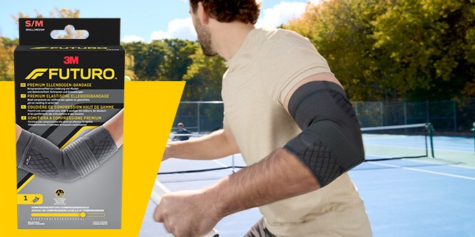 Tennisser met een FUTURO Premium elleboog-compressiebandage, met de productverpakking zichtbaar
